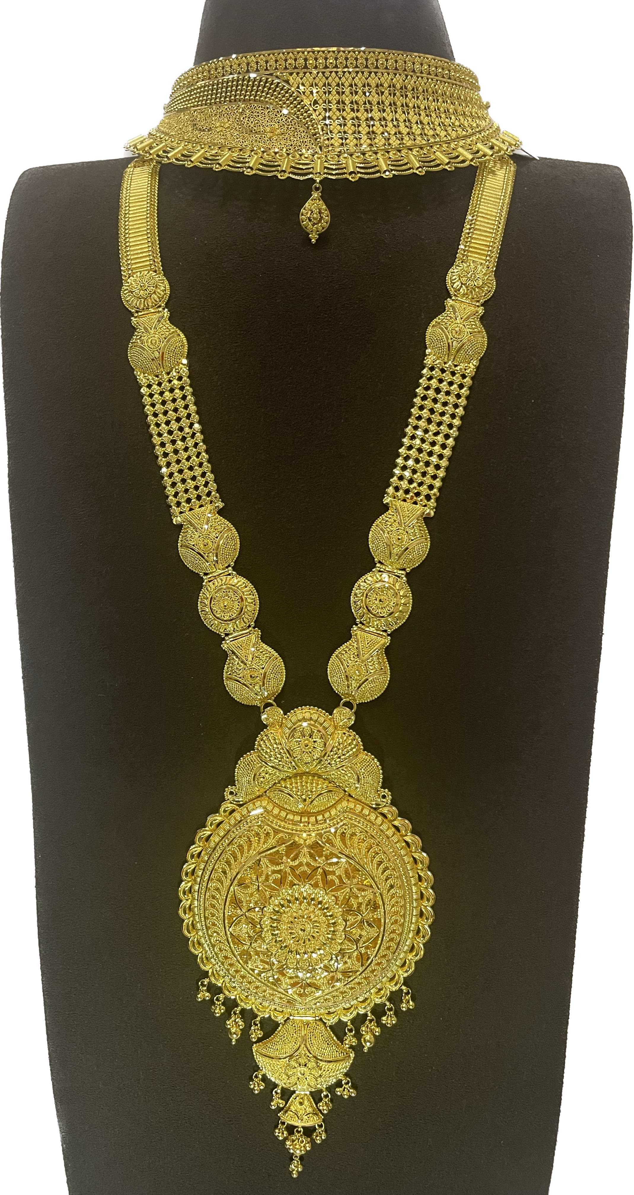 A broad choker and long necklace with a circular pendant.